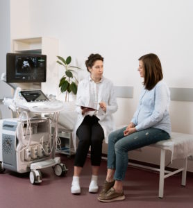 doctor consults patient at a hospital about bill related to hospital services as part of credit repair