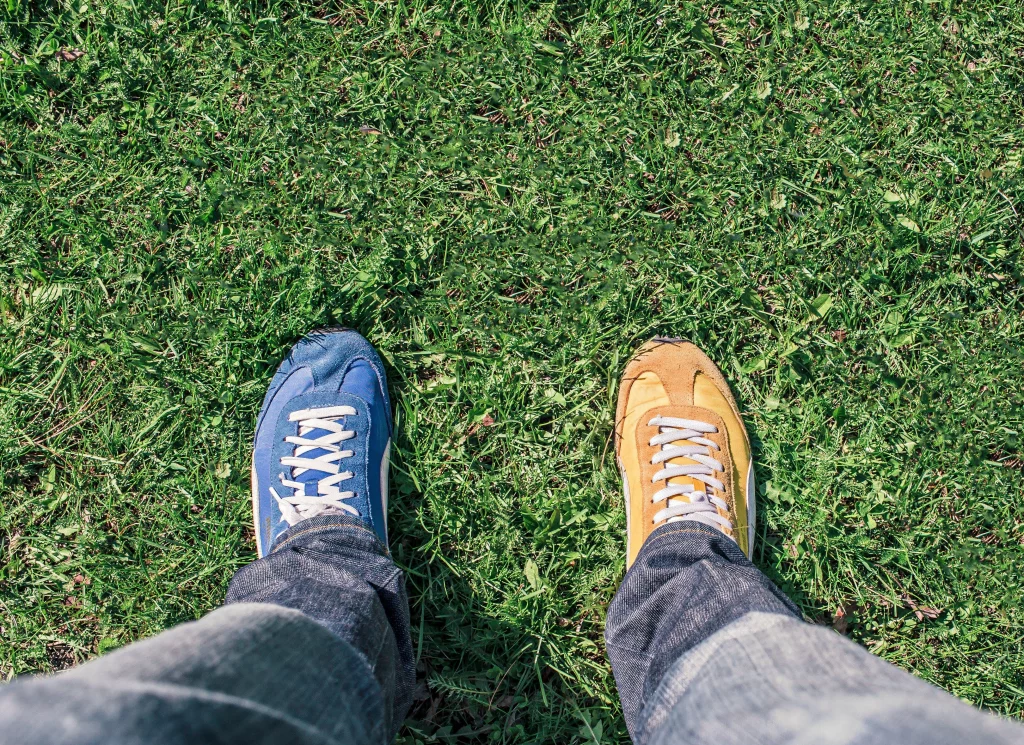 Person wearing two different shoes, illustrating the choice of credit freeze vs credit lock